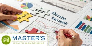 Image of a hand over paper charts and graphs with puzzle pieces and a red pen working on their 401k changes. The puzzle pieces say stocks, bonds, and on the paper is written alternative investments.
