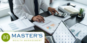 Man in a suit reviews his tax documents with a calculator while determining if tax-loss harvesting is right for him.