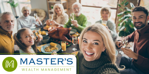 A family gathered for thanksgiving smiles while discussing the best giving strategies for tax benefits.