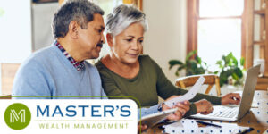 Retired couple goes over their financials at the end of the year using a checklist and a laptop.